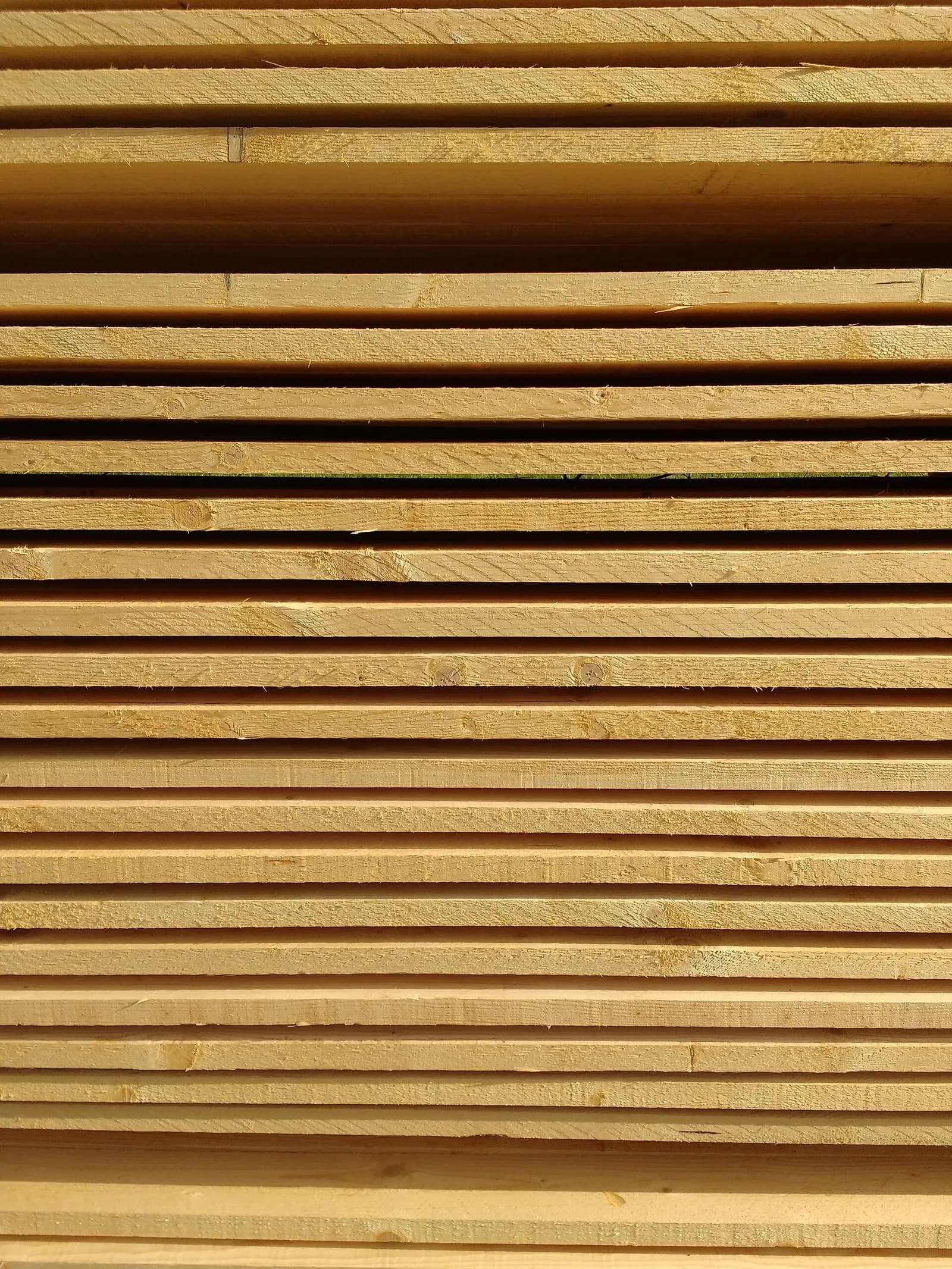 The edges of planed boards, stacked flat.