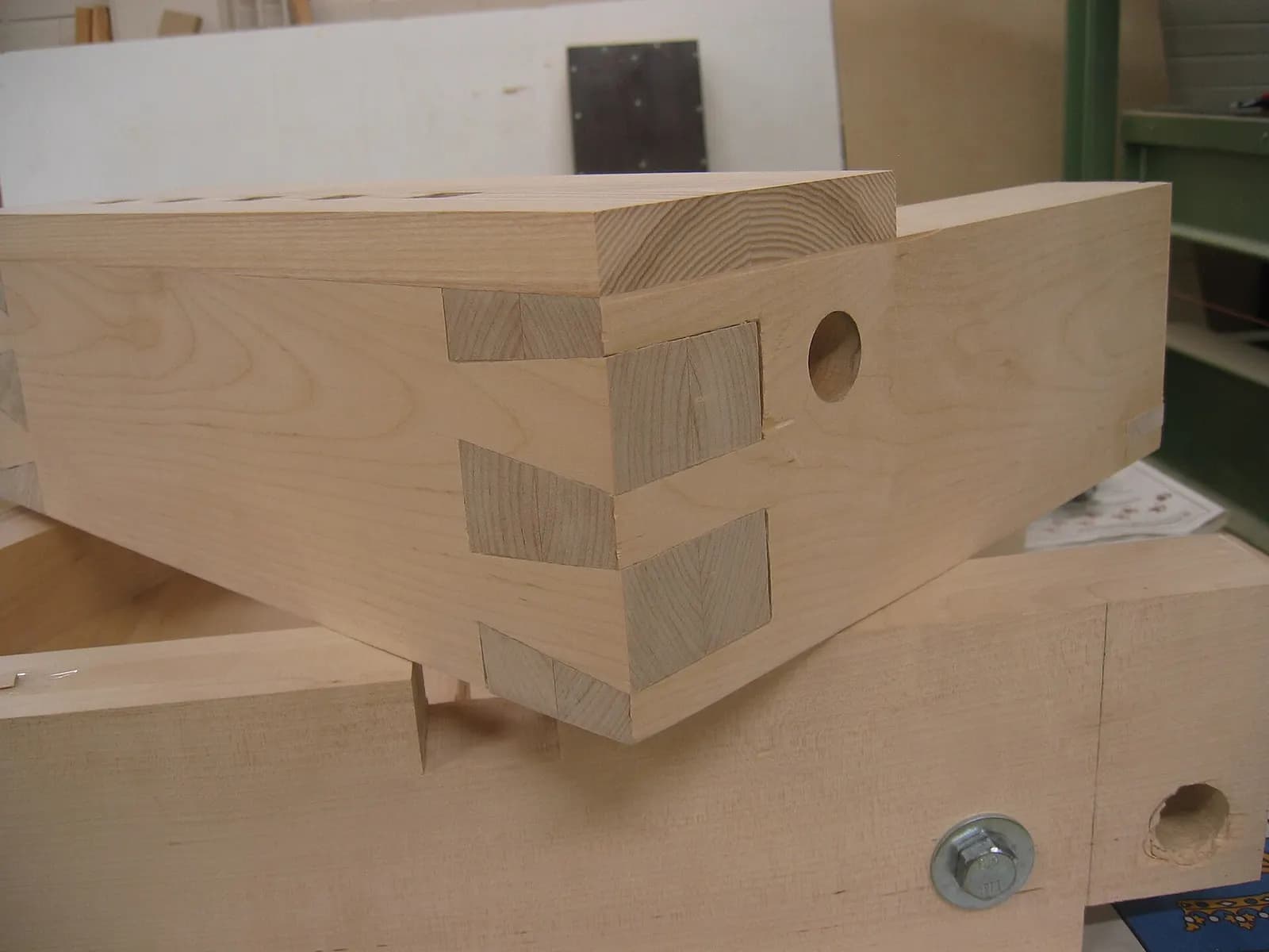 A cut wooden joint showing interlocking end grain.